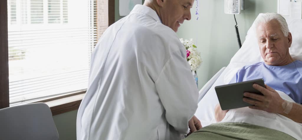 Doctor and patient using digital tablet in hospital Doctor and patient using digital tablet in hospital
